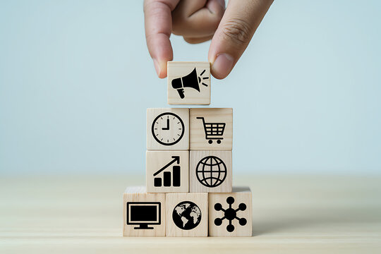 Hand stacking wooden blocks with icons