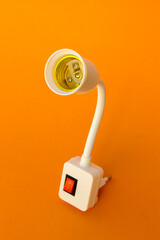 Naklejka premium White flexible neck lamp adapter socket with power switch on orange background