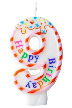 Number nine shaped birthday candle with colorful sprinkles