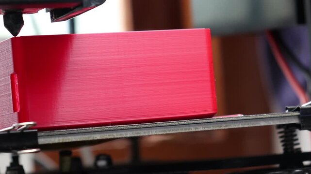 3D printer head moving precisely as it builds an object layer by layer through the process of additive manufacturing