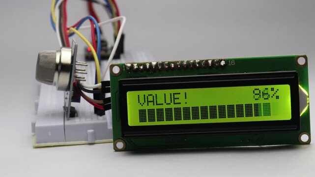Gas sensor module detects gas and triggers an onboard green LED while the LCD display shows sensor values