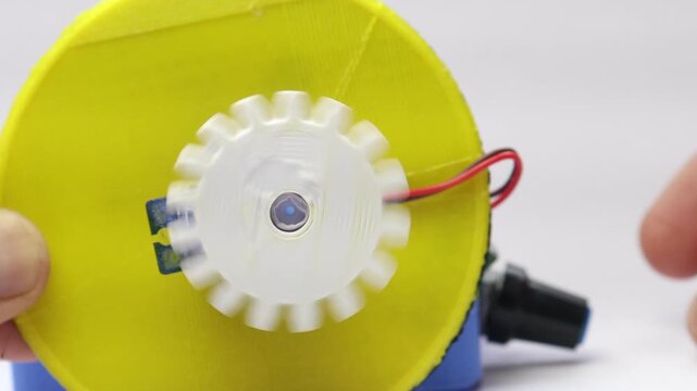 DC motor speed controller board activates the servo so its shaft spins a 3D printed gear
