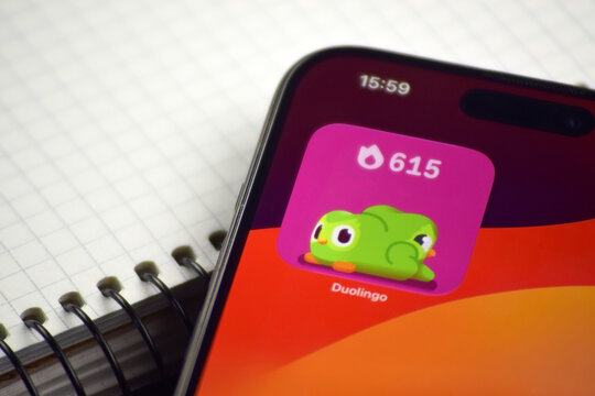 Kharkiv, Ukraine, 7 August 2026: Duolingo app on the smartphone iPhone 15 screen. Grey background