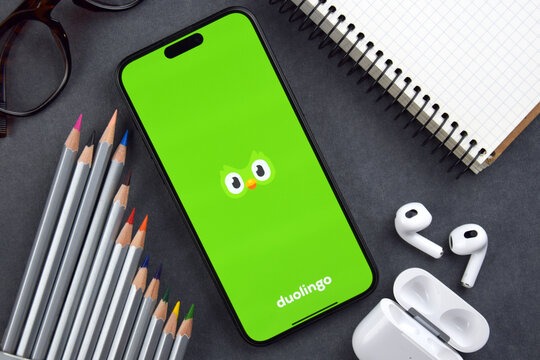 Kharkiv, Ukraine, 7 August 2026: Duolingo app on the smartphone iPhone 15 screen. Grey background