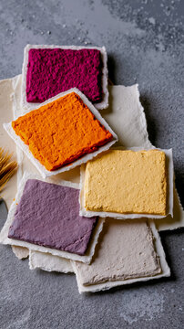 A variety of different colored squares of cake on a table
