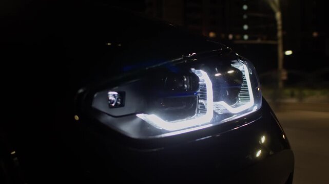 Modern car driving city road at night