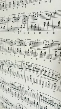 Close up of sheet music book with handwritten chords and musical notes, artist, musician, composer