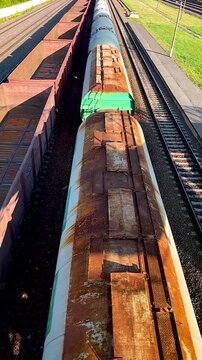 Slow motion top view freight train moving on railway