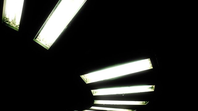 Scary neon light fixture in a circular shape with glowing white lines, flickering defect. Futuristic aesthetics.
