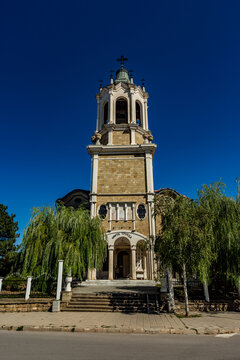 Tall tower with a clock on it in the middle of a street, Svishtov, Bulgaria, Saint Trinity church