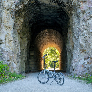 Folding bike on Katy Trail at a tunnel near Rocheport, Missouri, spring scenery. The Katy Trail is 237 mile bike trail converted from an old railroad.