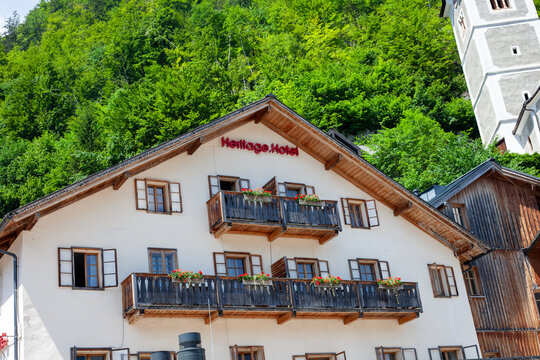 Facade of Heritage Hotel in Hallstatt, Austria, with Traditional Wooden Balconies and Flower Boxes. Hallstatt, Austria - June 22, 2026