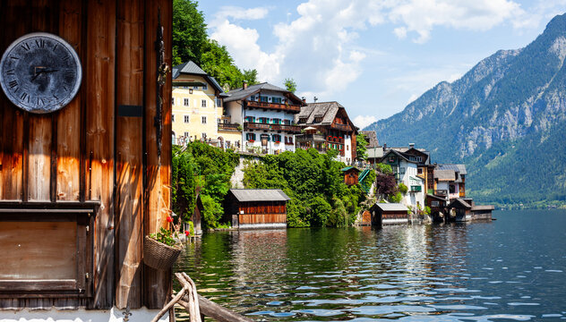 Hallstatt Lake, with Wooden Clock, Houses and Mountains in Austria.