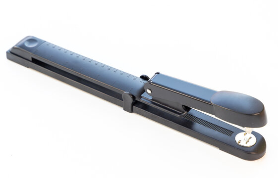 Black Office Stapler Tool Diagonally Resting on Clean White Background