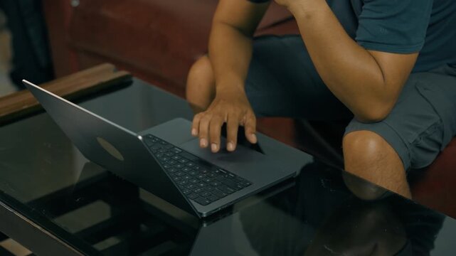 Closeup of man hands using touchpad on laptop keypad. Unrecognized freelancer browsing internet computer doing online report in agency. Student employee study remotely at desk.