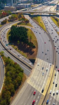 Wide highway cutting through Atlanta city center with steady traffic flow and modern urban architecture.