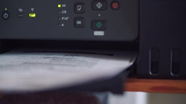 Office Printer Producing Color Business Document on Paper