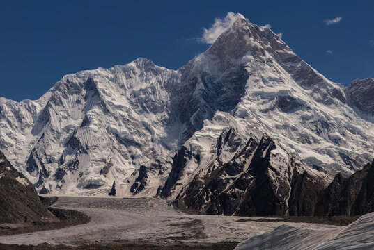 View of the snow-capped peak of Mashabrum, also known as K1, rising above the Goro II glacier in the Karakoram Range, Gilgit Baltistan, Pakistan.