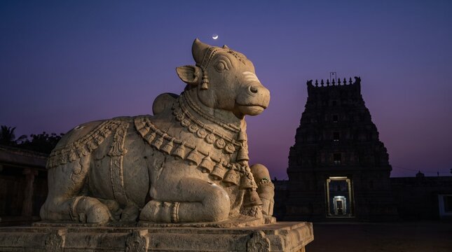 Steel blue to shadow black gradient with Nandi statue under crescent moon and temple silhouette