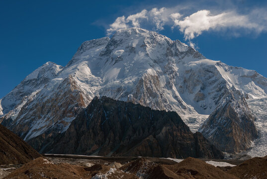 View of Broad Peak rising above the rocky terrain of the Concordia camp in the Karakoram Mountain Range, Gilgit Baltistan, Pakistan.