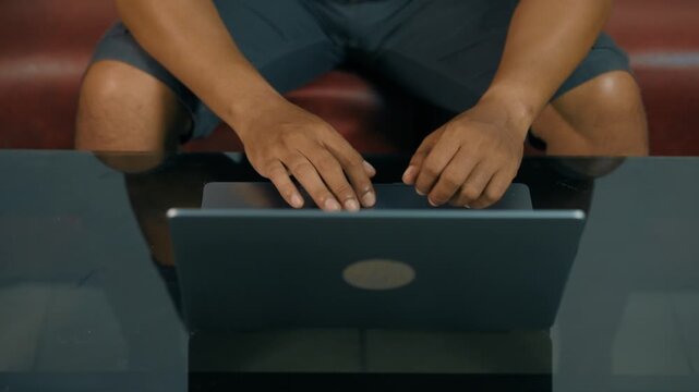 Closeup of man hands using touchpad on laptop keypad. Unrecognized freelancer browsing internet computer doing online report in agency. Student employee study remotely at desk.