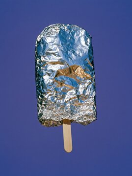Emergency Blanket Ice Pop with Fine Silver Wrinkles on Electric Purple Background