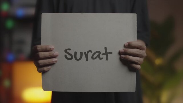 Surat Written on Banner &ndash; Man Holding Placard