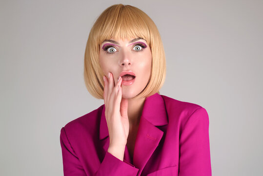 Close up photo of impressed woman isolated over studio background. Portrait of an excited young girl looking in excitement. Young woman shocked with surprise expression, amazed and excited face.