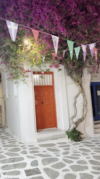 Traditional White Church with Colorful Festival Flags in Mykonos, Greece