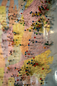 Large wall map of the United States densely covered with hundreds of colorful pushpins marking locations across the country, with particularly heavy concentrations along the Midwest
