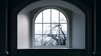 Fototapeta premium An elegant arched window frames bare tree branches against a bright sky set within a dark architectural alcove