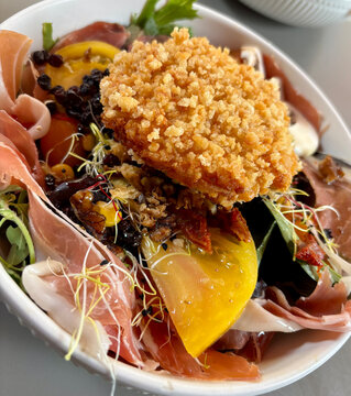 A delicious bowl of salad with crispy fried food on top