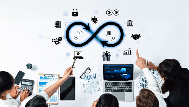 A business team collaborates over data trends with digital icons and financial charts surrounding an infinite loop concept on a modern workspace. Trope
