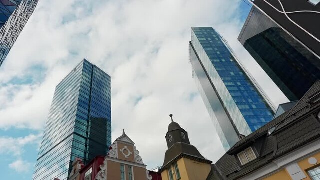 Modern skyscrapers rising above high-rise financial district buildings.