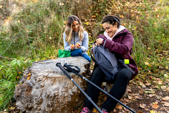 Friends resting during nordic walking activity in autumn nature