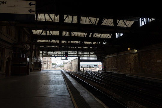 Empty train station platform in Perth, Scotland with railway tracks and infrastructure