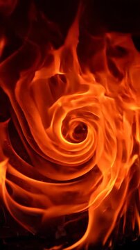 Abstract fire flames swirling against a dark background creating a dynamic heat texture.