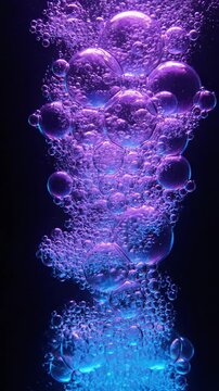 Abstract underwater bubbles rising in purple and blue light on a dark background.