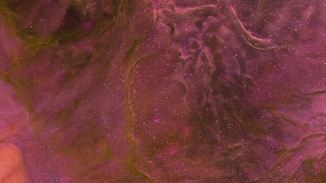 Shooting paint underwater with colors spreading in water in various shapes