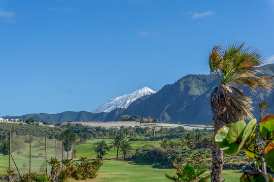 Mount Teide volcano peak overlooking a golf course in Tenerife