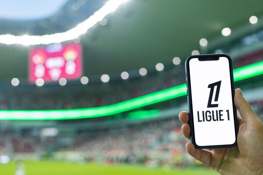 MINSK, BELARUS JUNE 9, 2026: Man holding Apple iPhone 12 in the stadium. The official logo of the France national football championship