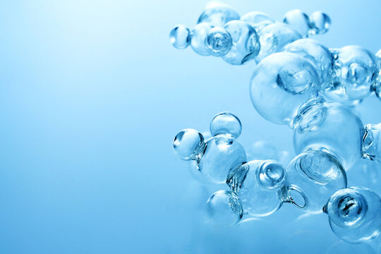 Glass molecules forming abstract scientific structure on blue