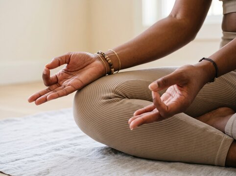 Close-up of woman's hands during a yoga practice showcasing mindfulness, balance, meditation and holistic wellness