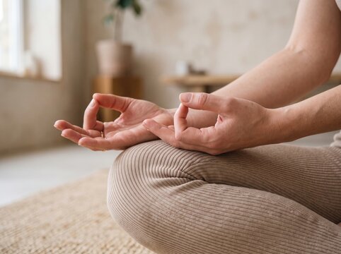 Close-up of woman's hands during a yoga practice showcasing mindfulness, balance, meditation and holistic wellness