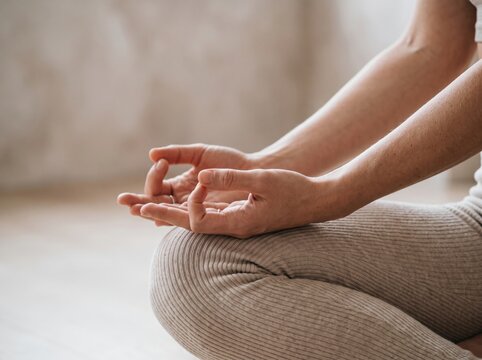 Close-up of woman's hands during a yoga practice showcasing mindfulness, balance, meditation and holistic wellness