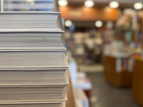 Close-up of a stack of books in a bookstore, diverse reading collection and literary culture concept