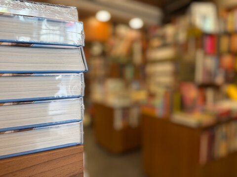 Close-up of a stack of books in a bookstore, diverse reading collection and literary culture concept