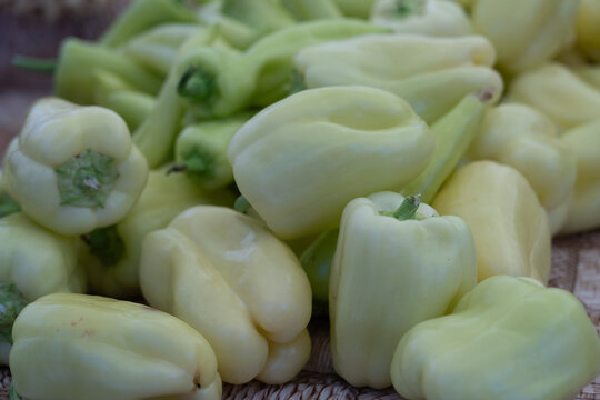 Fresh locally grown green bell peppers  at a farmers market, seasonal farm produce and sustainable local food concept