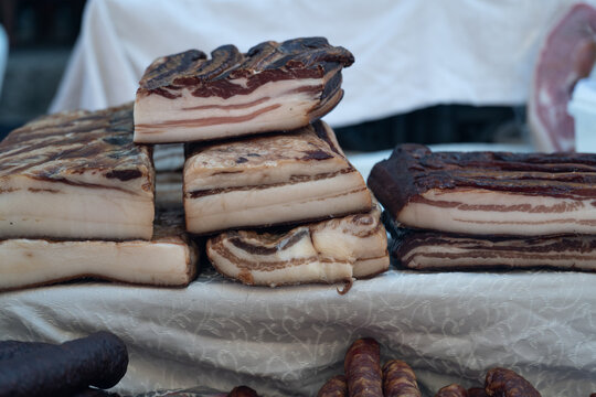Fresh traditional cured ham displayed at a local farmers market, artisanal meat product and authentic regional food concept