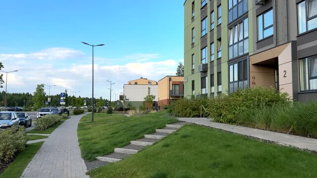 Modern Residential Building in neighborhood. Duplex Townhouse at Lush Greenery and Pathways. Walkway in contemporary apartment complex. Pathways at modern townhouse with private courtyards 